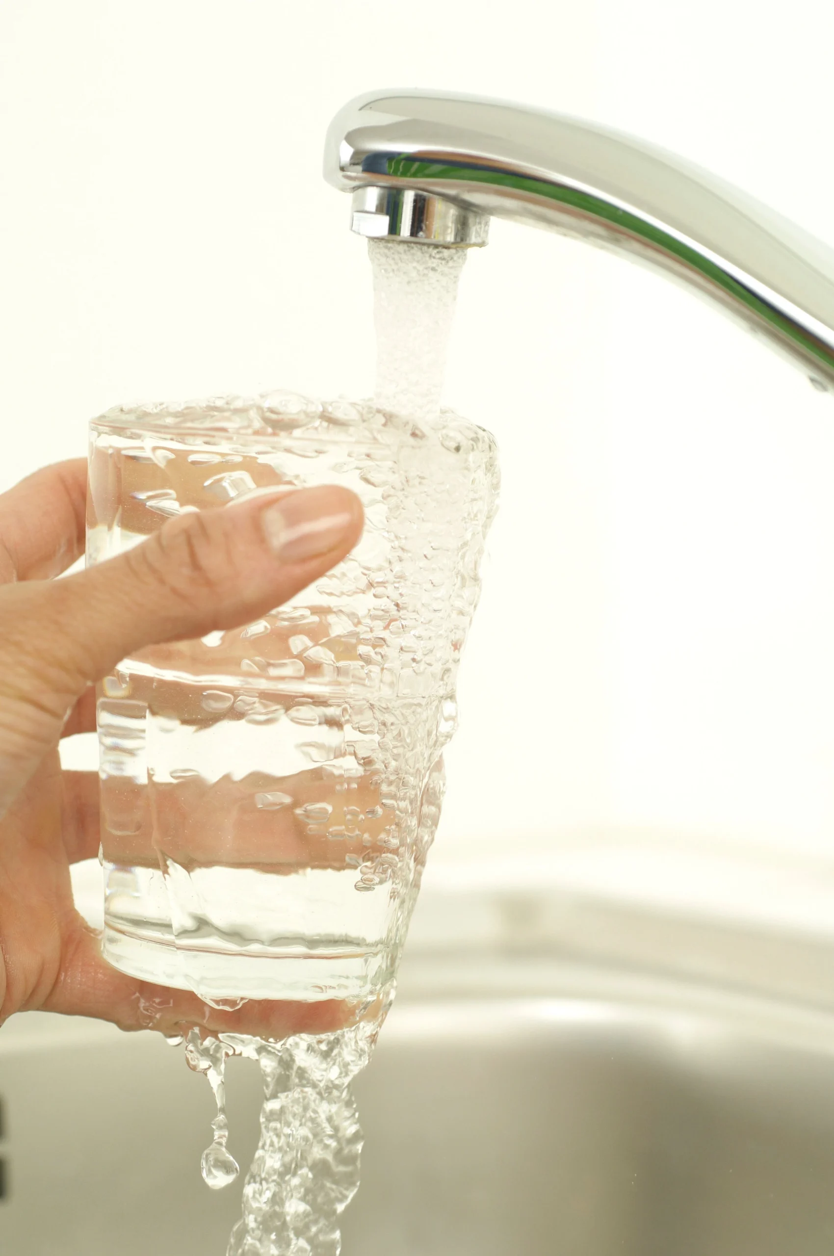 hand holding glass of purified tap water