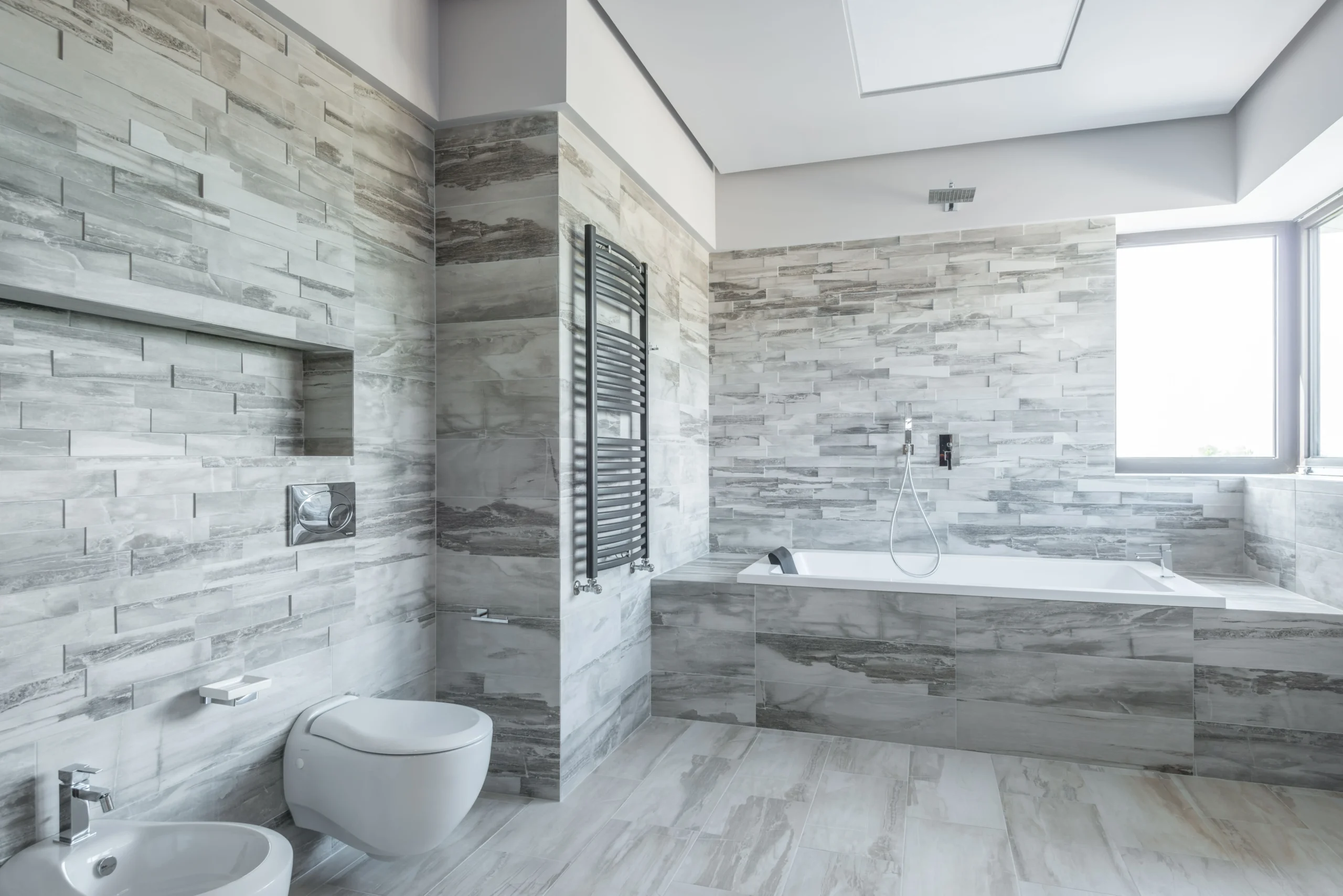 grey and white tiled bathroom with stone finish