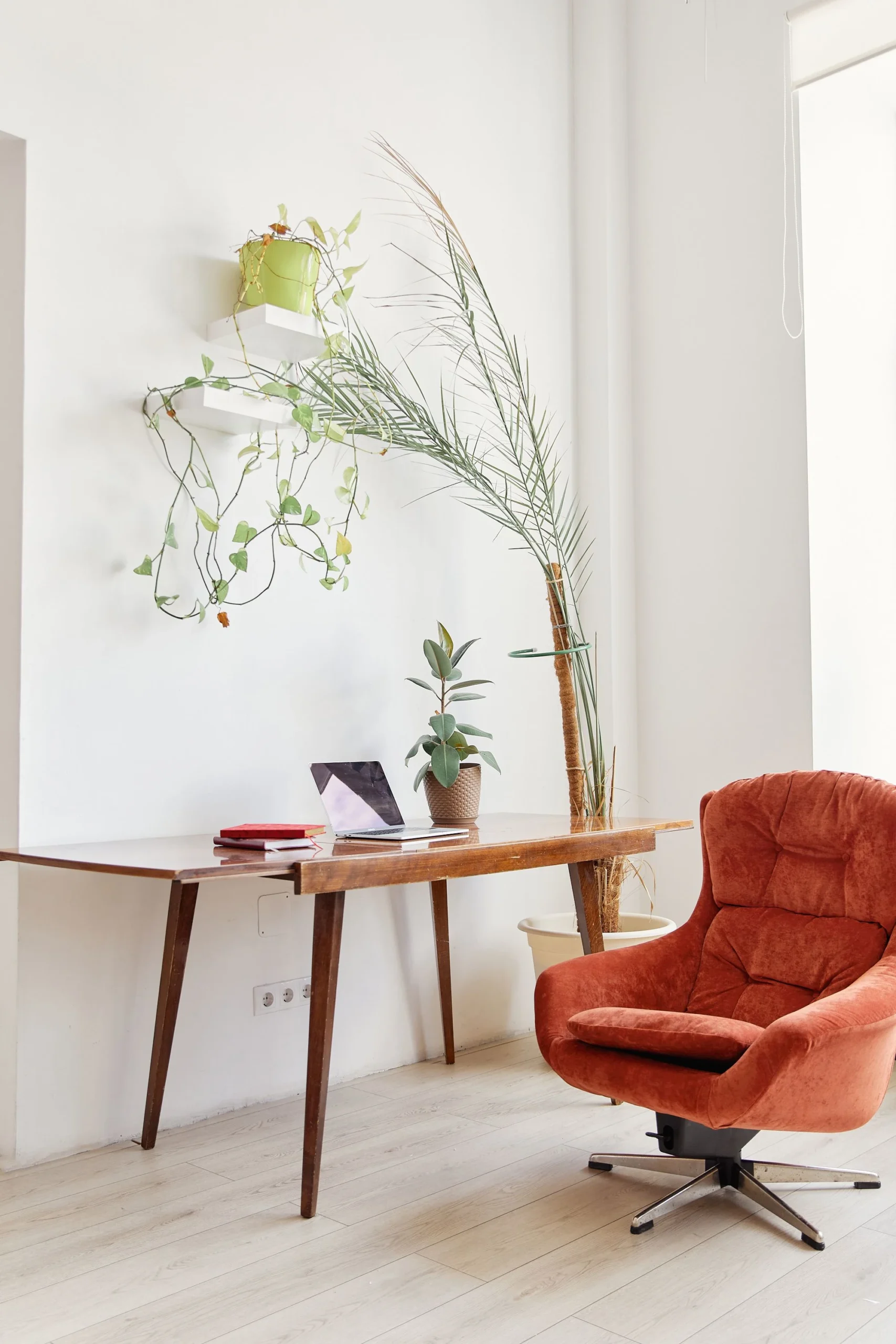 bright home office setup with red chair and wooden desk